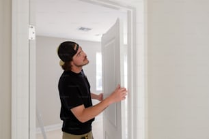 a man in a black shirt is opening a door