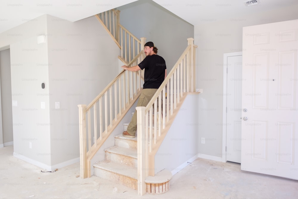 a man standing on a stair case in a house