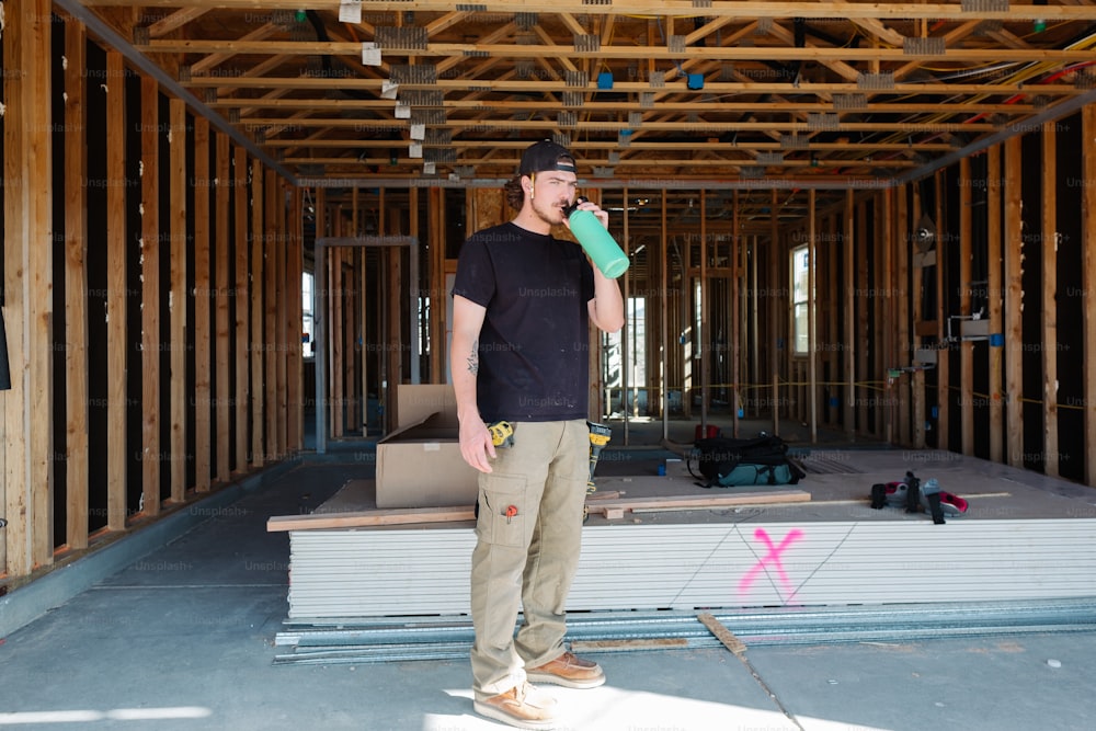 a man standing in front of a building under construction