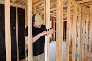 a man is working on framing a house