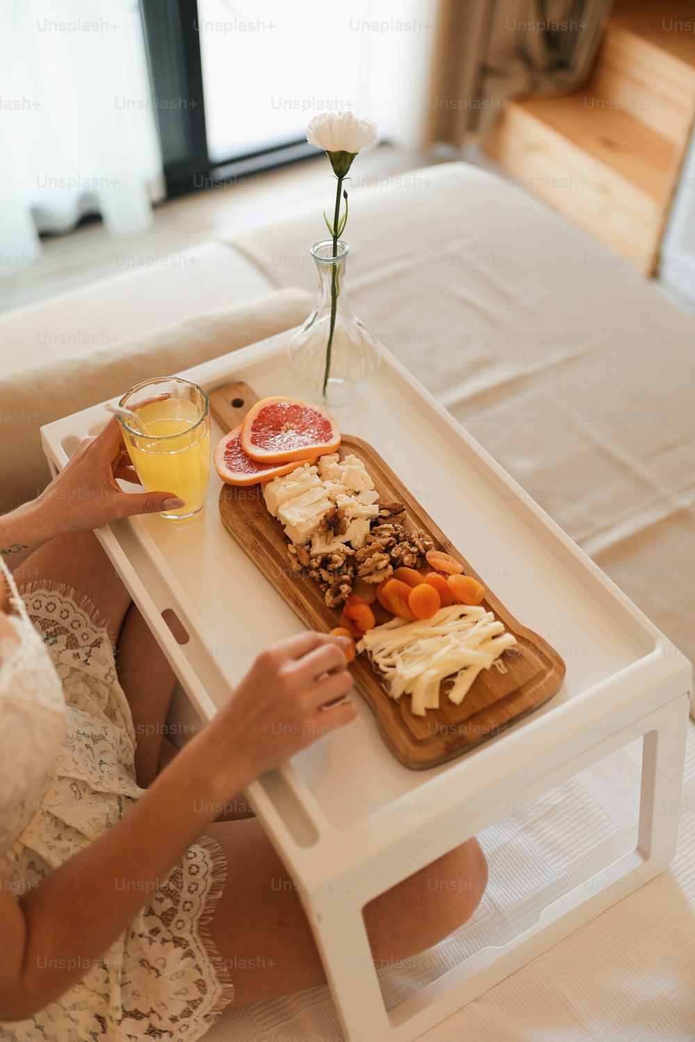 a woman sitting at a table with a tray of food