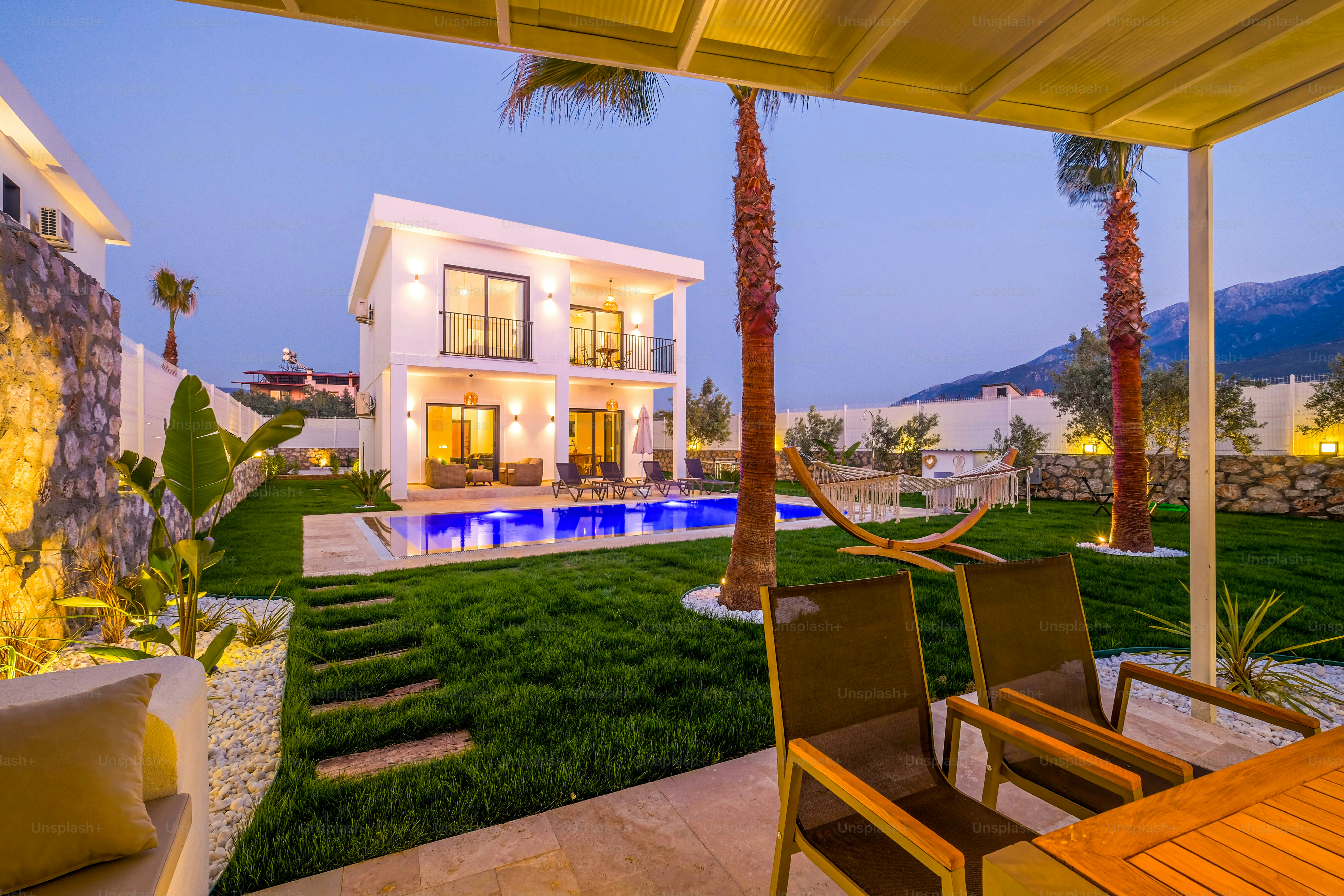 a house with a swimming pool and lawn