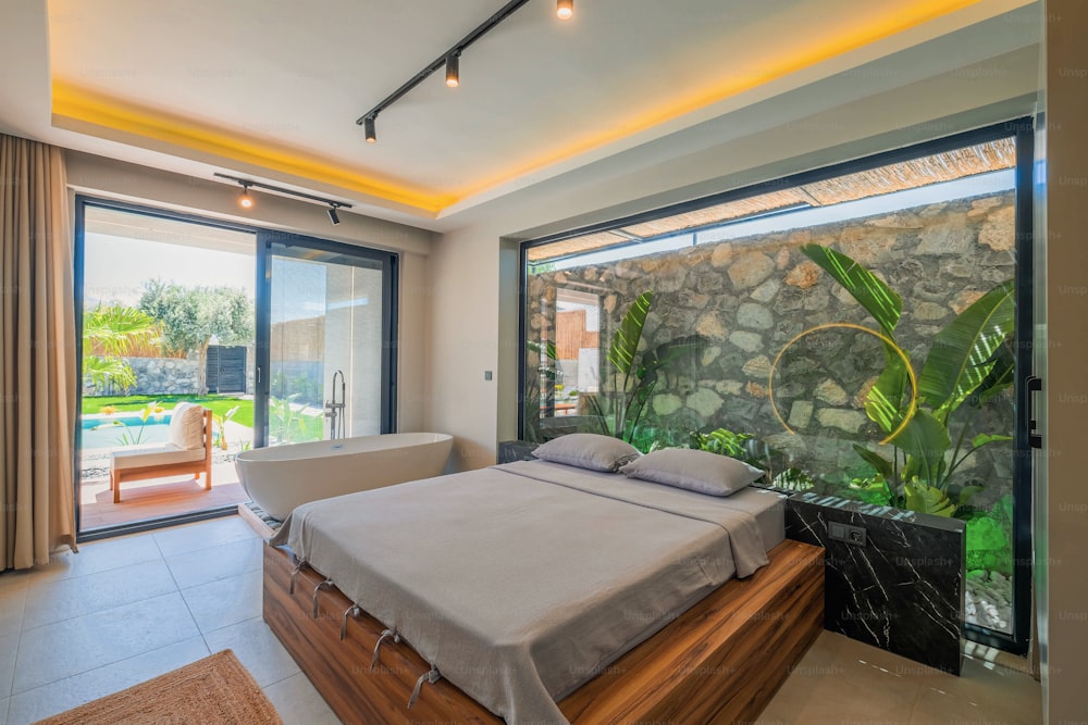 a bedroom with a stone wall and sliding glass doors