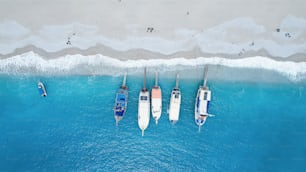 a group of boats floating on top of a body of water