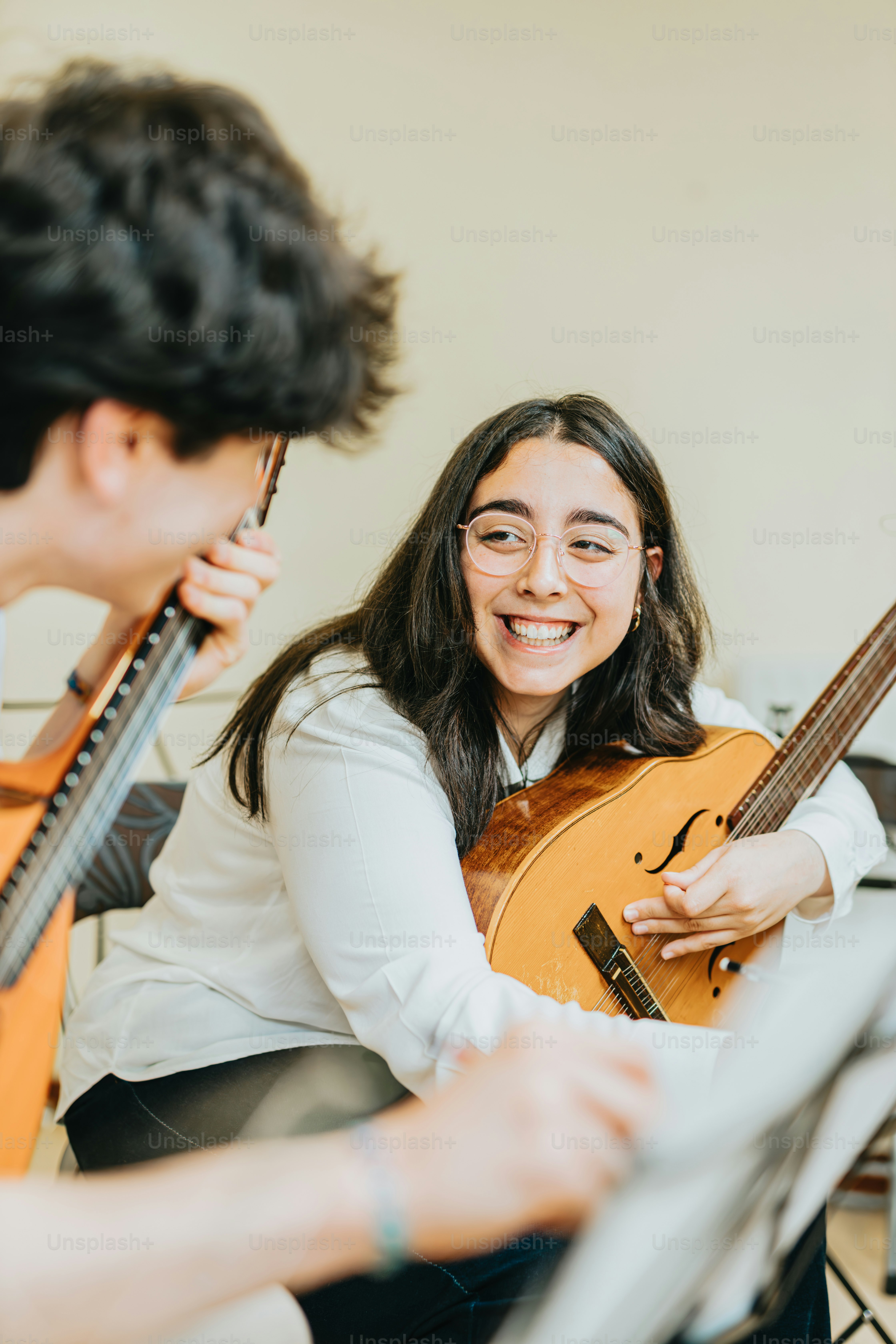 기타를 들고 있는 남자 옆에 앉아 있는 여자