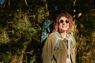 a woman with red hair wearing a backpack