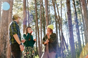a group of people standing next to each other in a forest