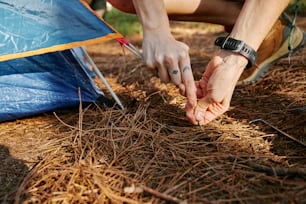 a person putting a ring on their finger next to a tent