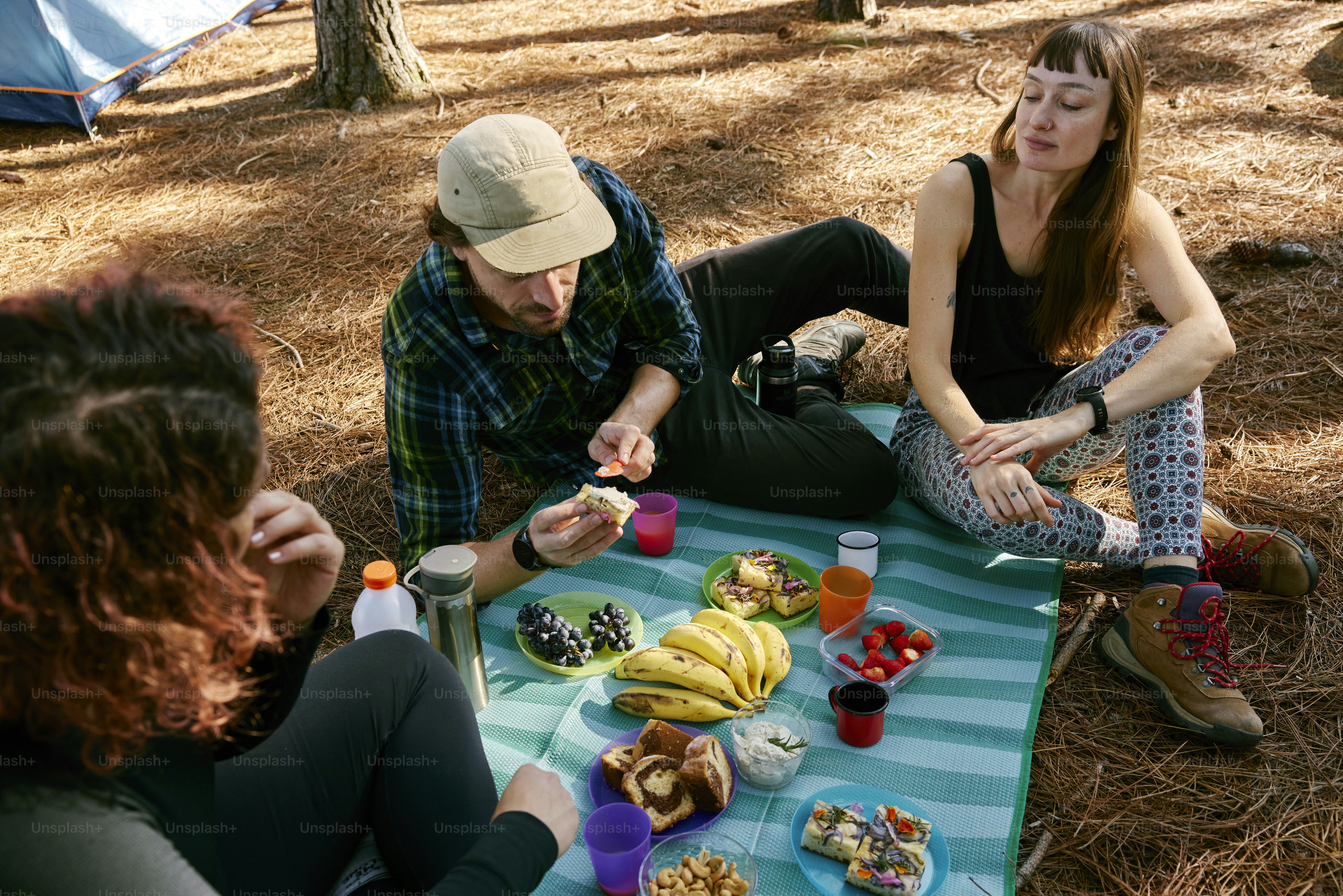 a group of people sitting around a table with food on it