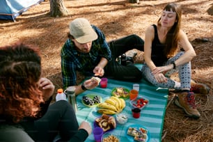 a group of people sitting around a table with food on it