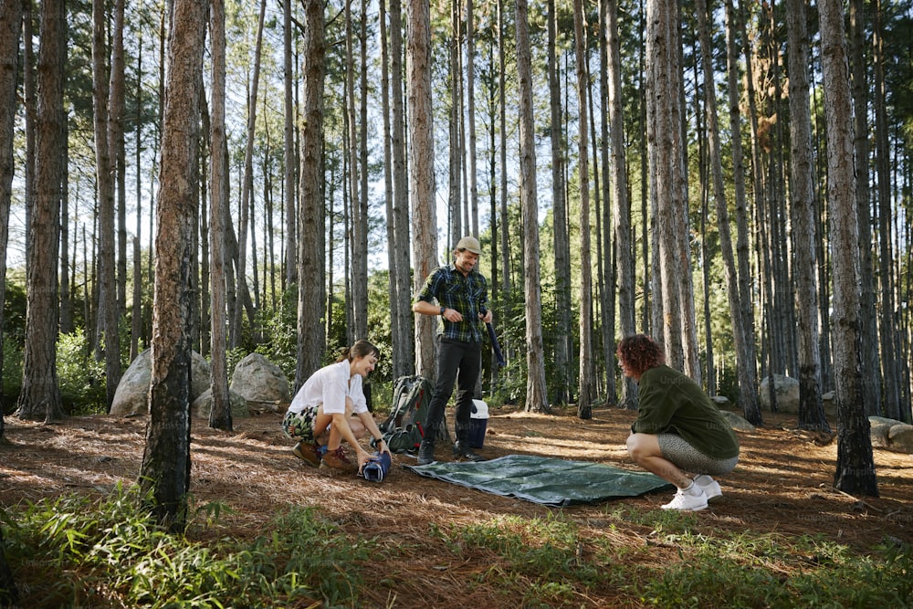 a group of people standing around a forest