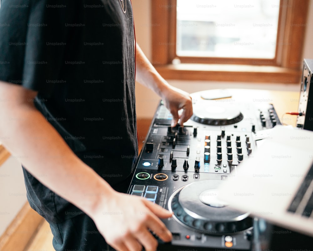 a dj mixing music in front of a laptop