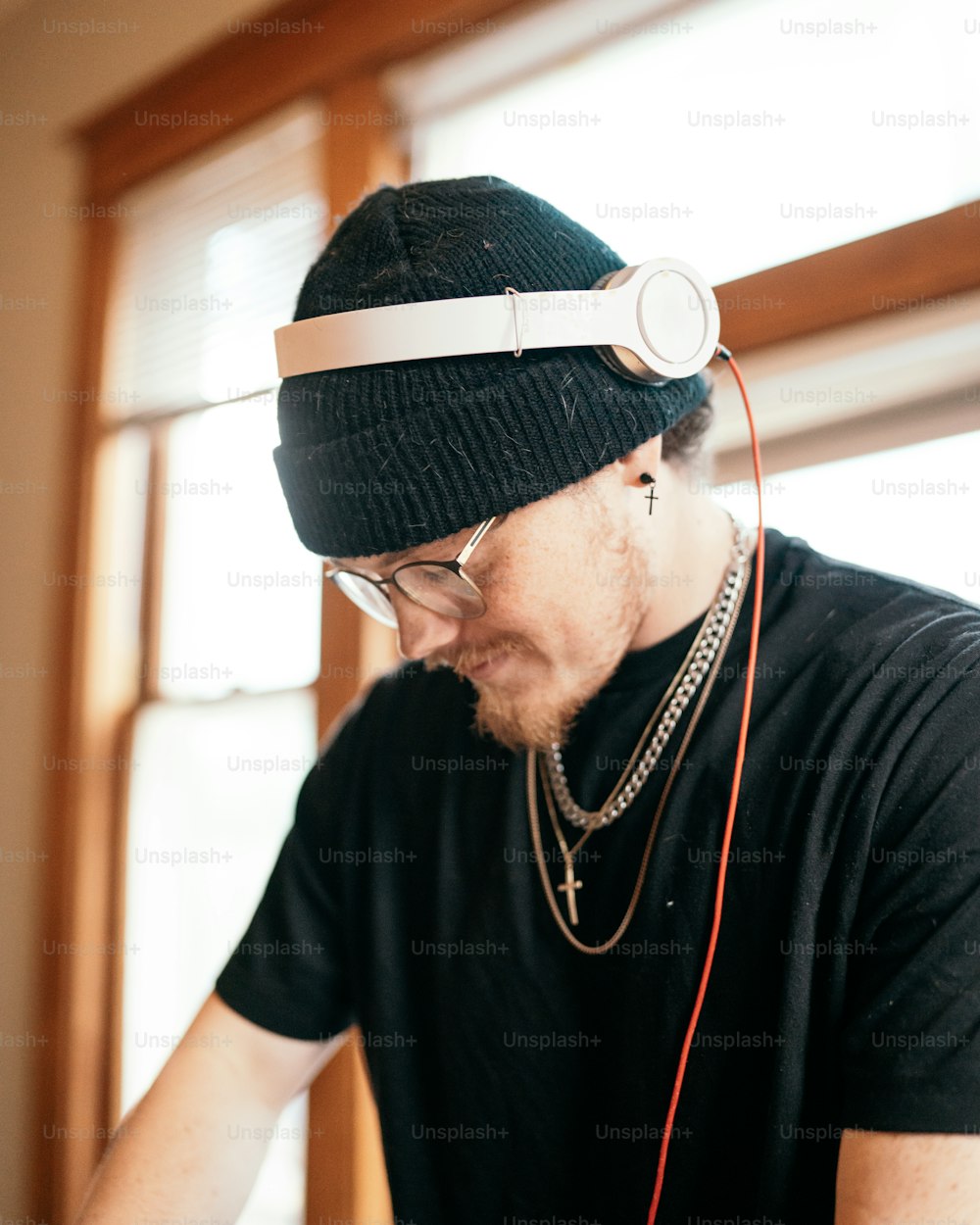 a man wearing headphones and a beanie