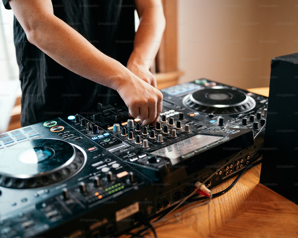 a dj mixing music on a large dj deck