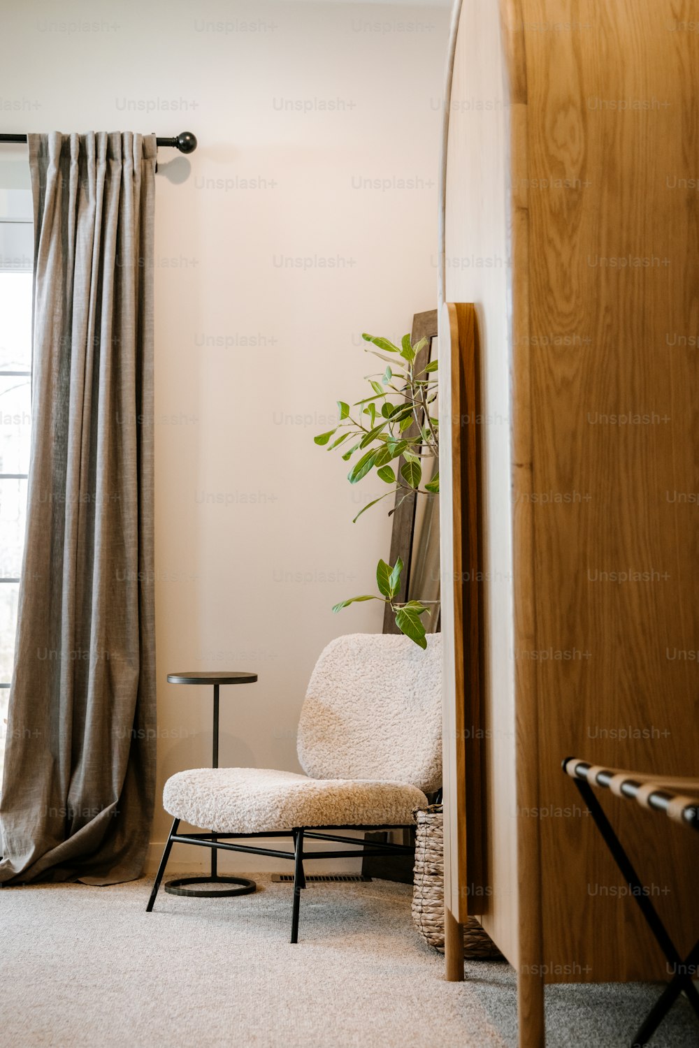 a living room with a chair and a plant