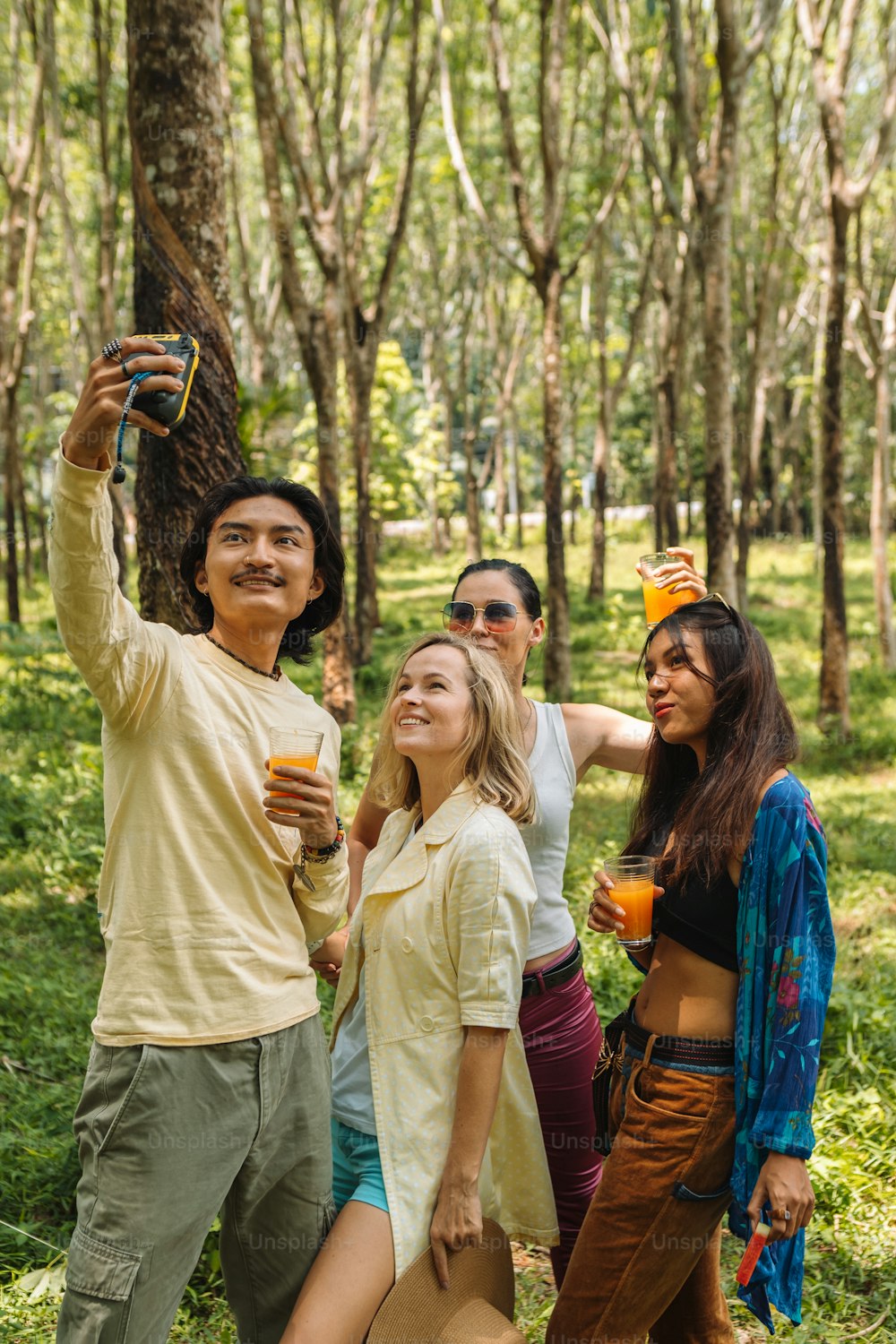 a group of people standing around each other in the woods