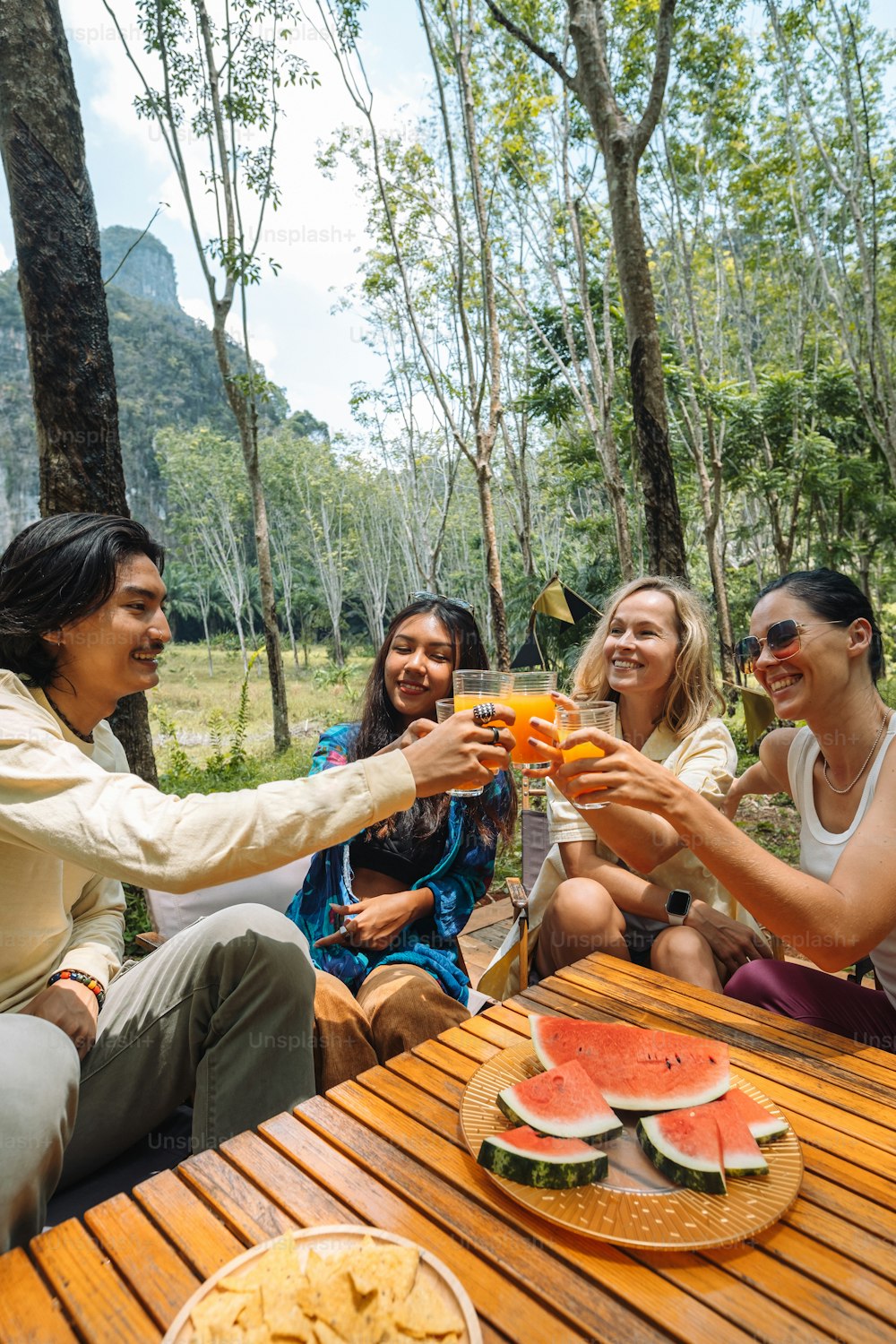 a group of people sitting around a wooden table