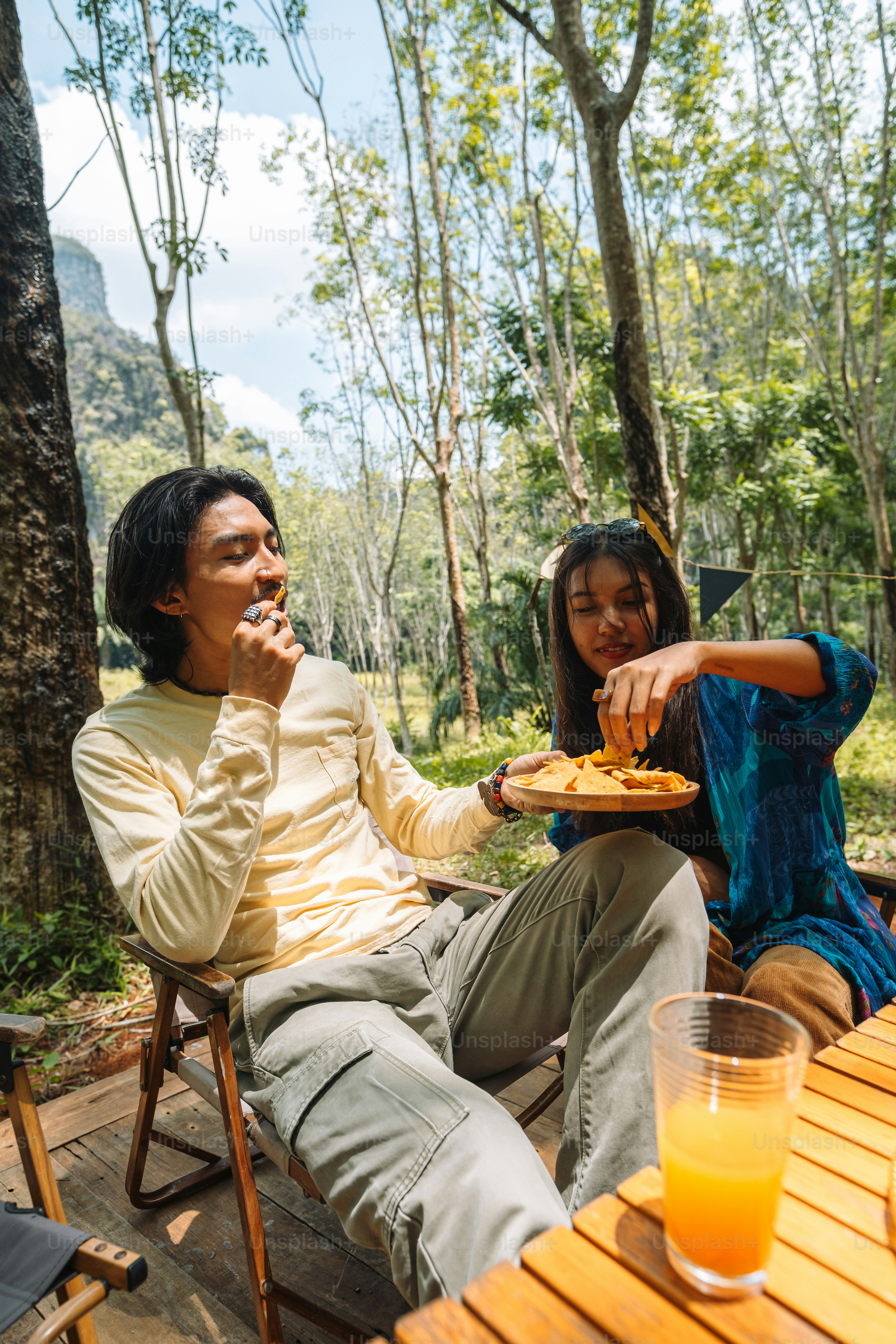 a man and a woman sitting at a table eating food