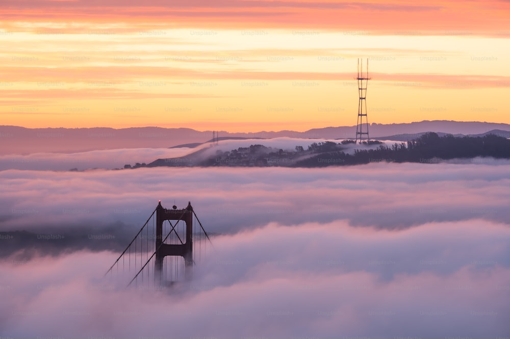 a tower in the middle of a sea of clouds