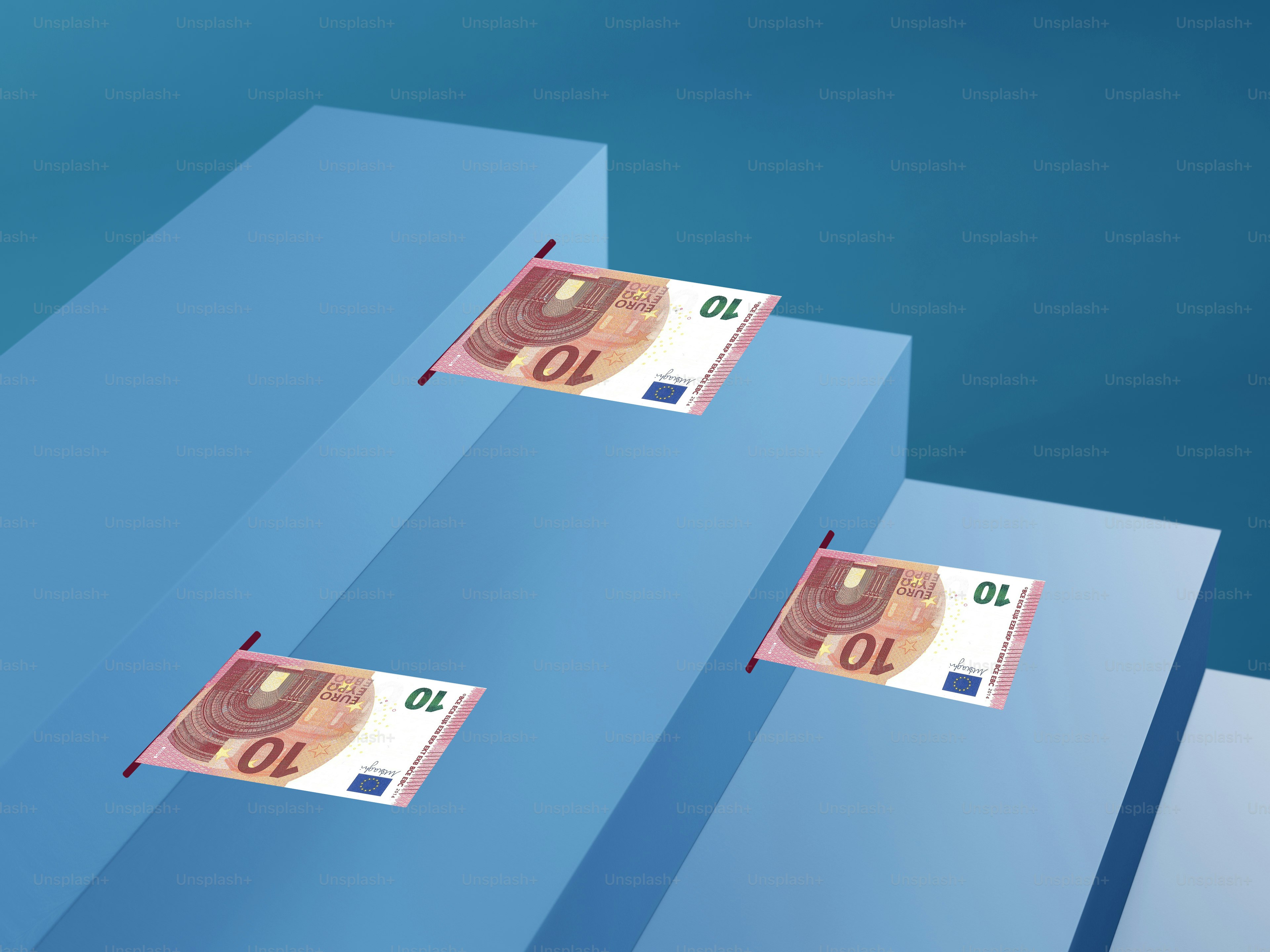 three stacks of money floating over a blue background