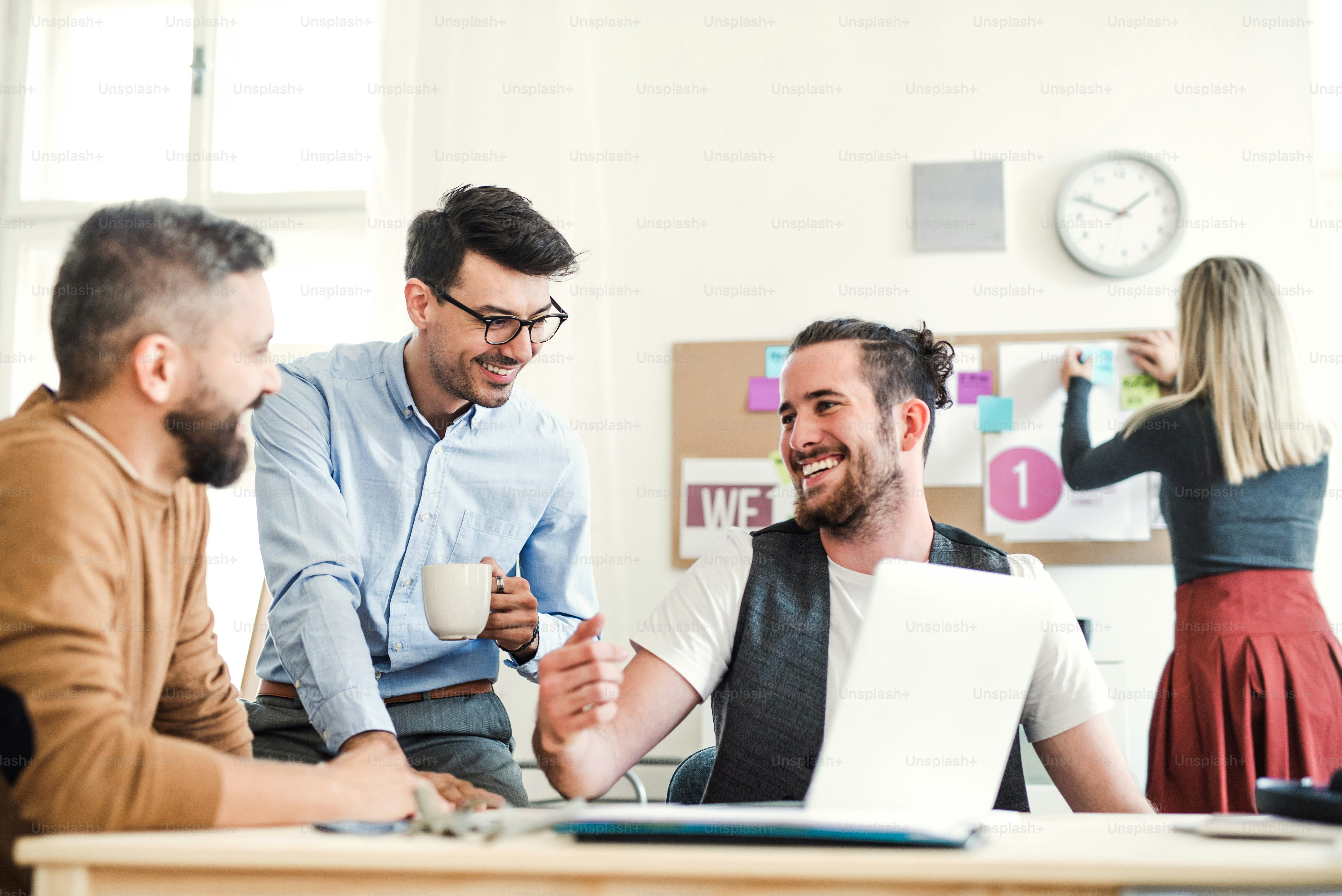 A portrait of group of young businesspeople standing in a modern office ...