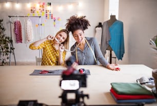 A camera with a slider and creative women in a studio. Startup business.