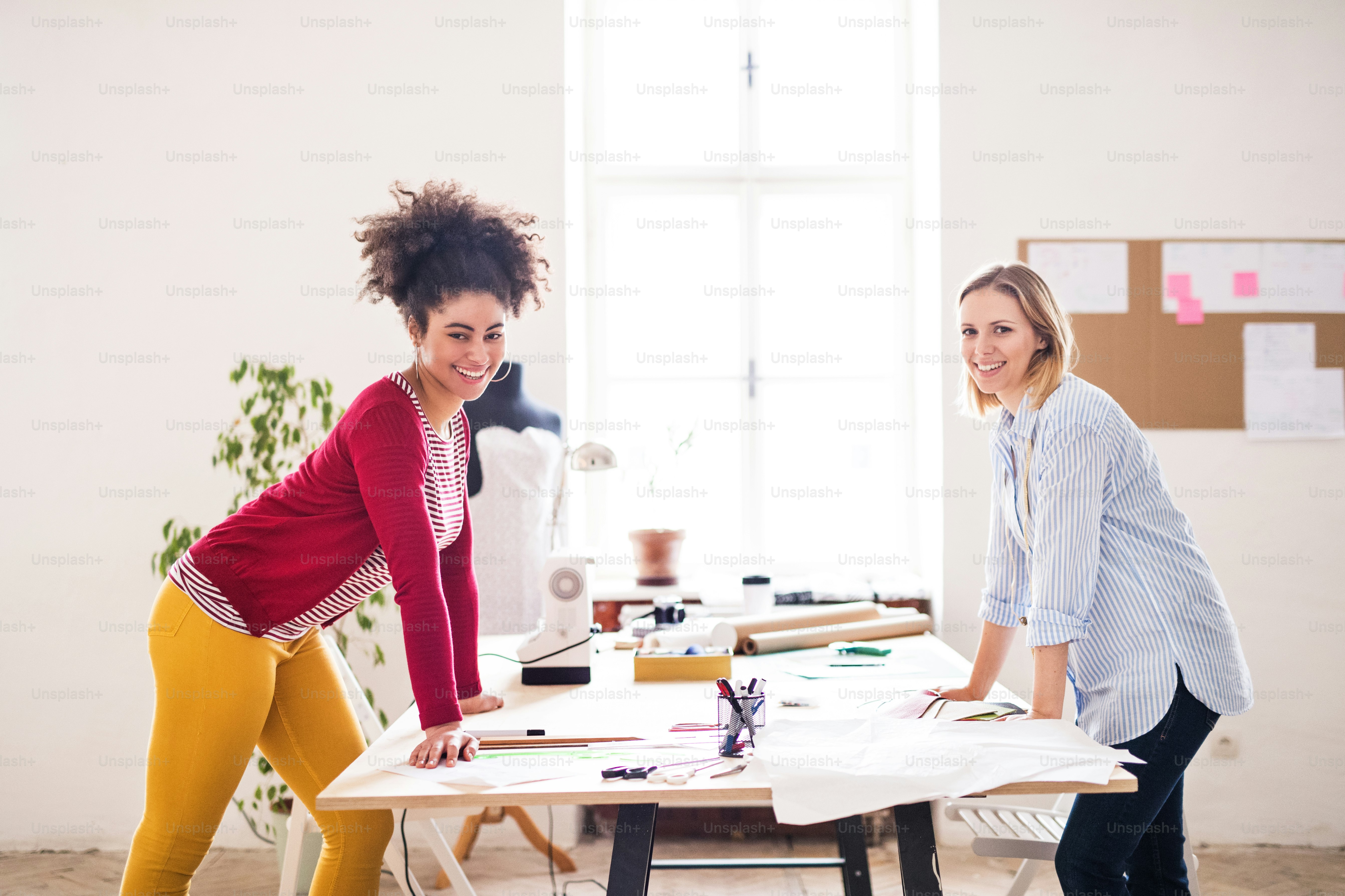 Young creative women in a studio, having fun. Startup business. photo ...