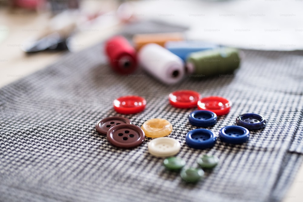 Buttons and thread bobbins on a fabric. Startup business.