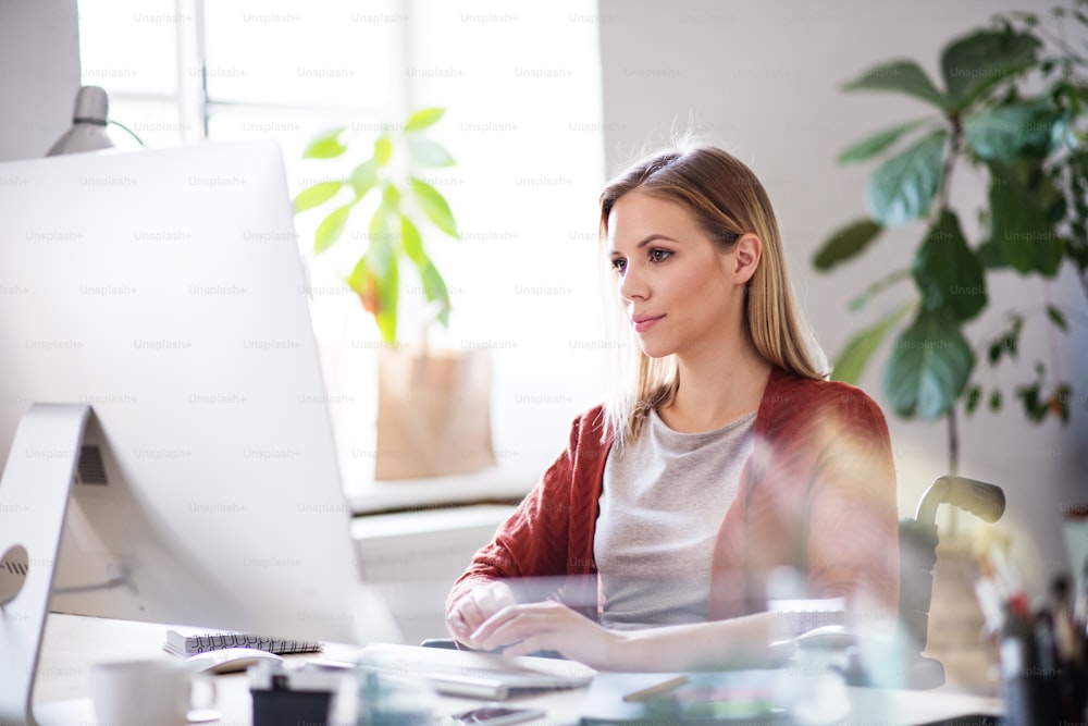 Businesswoman in wheelchair sitting at the desk, working.