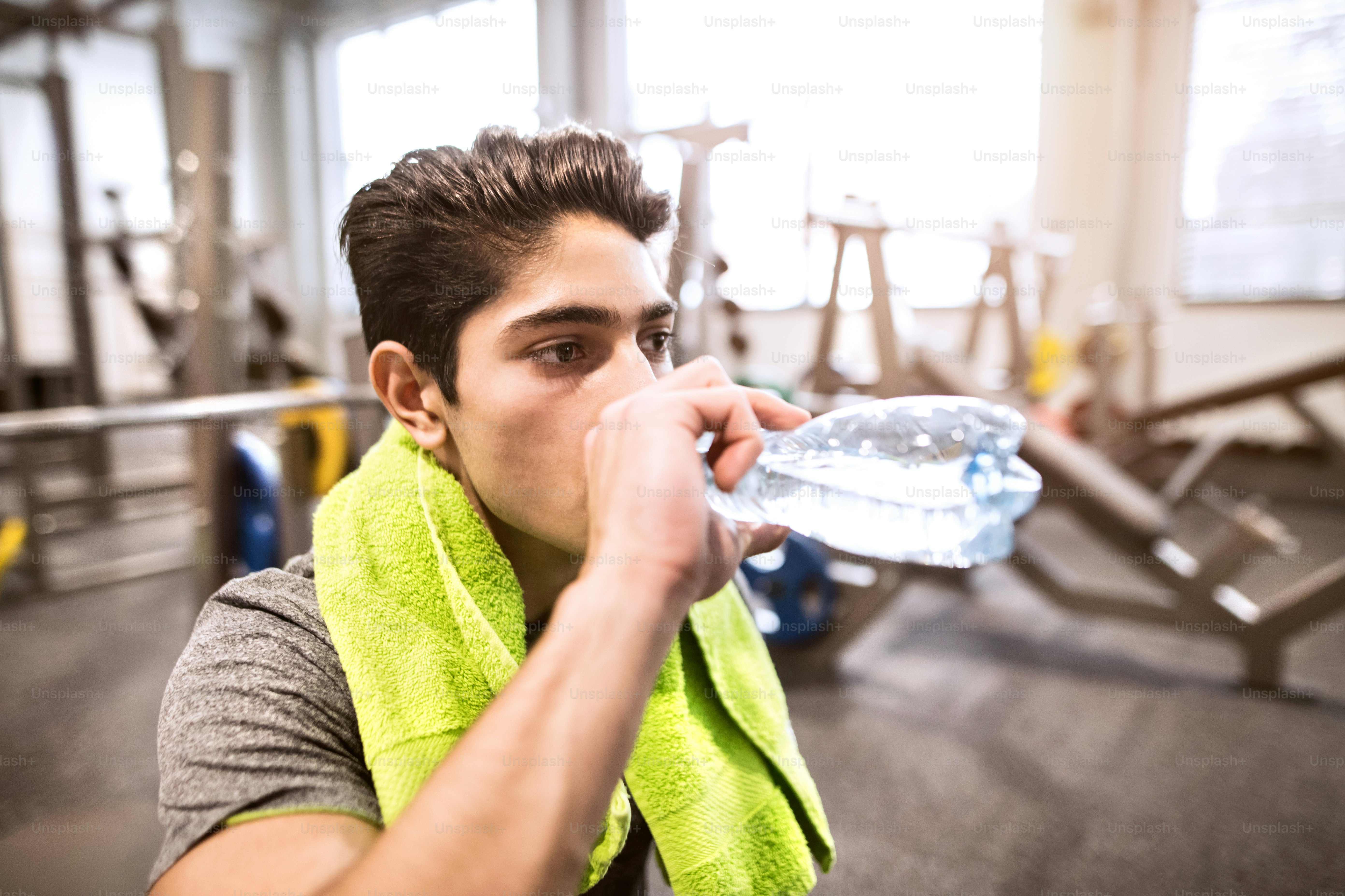 Hispanic fitness man resting in gym, drinking water photo – Drinking ...