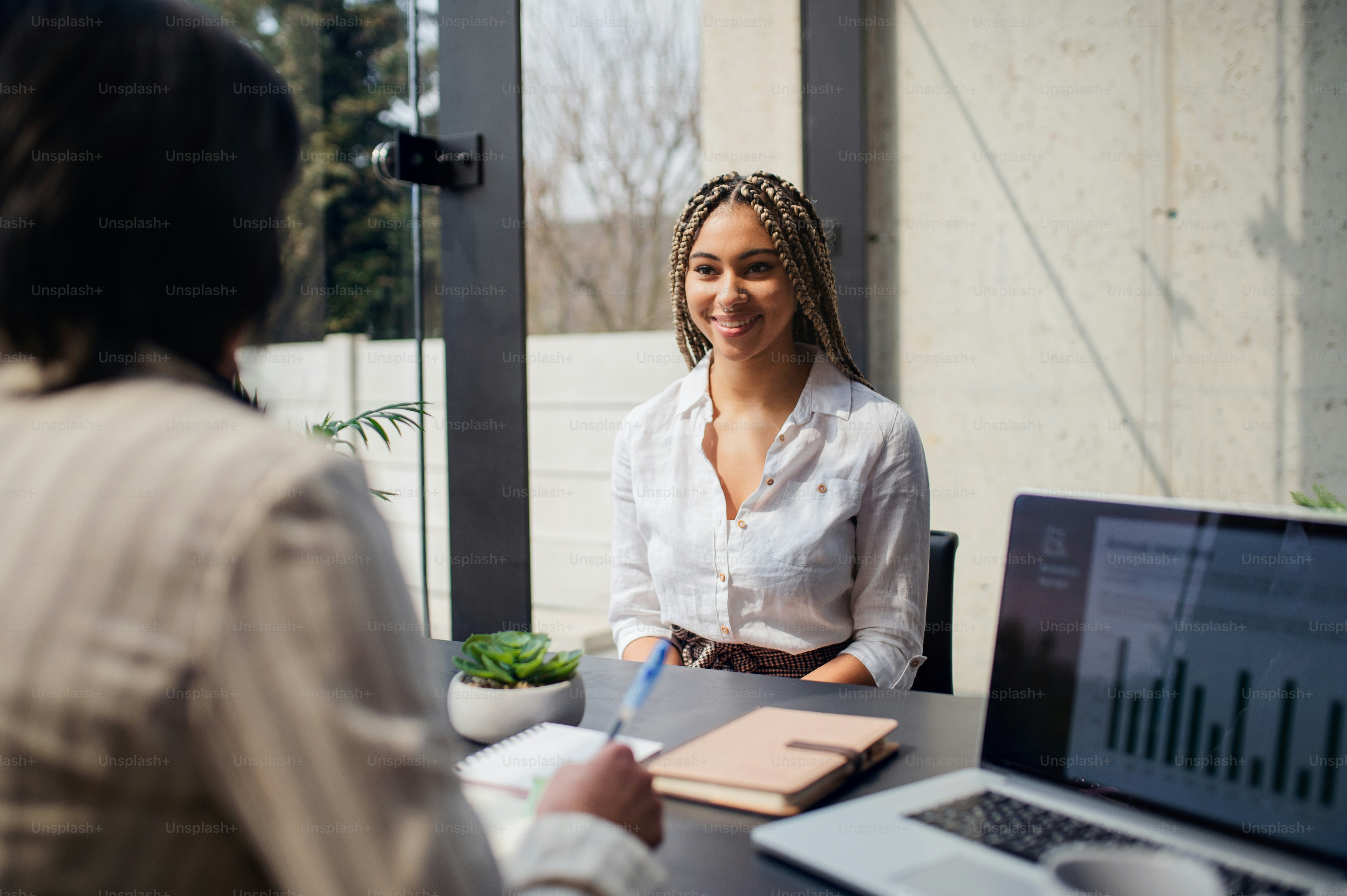 A happy young woman having job interview in office, business and career ...