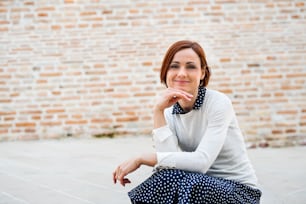 A portrait of young business woman standing outdoors. Copy space. Start-up concept.