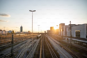 the sun is setting over the train tracks