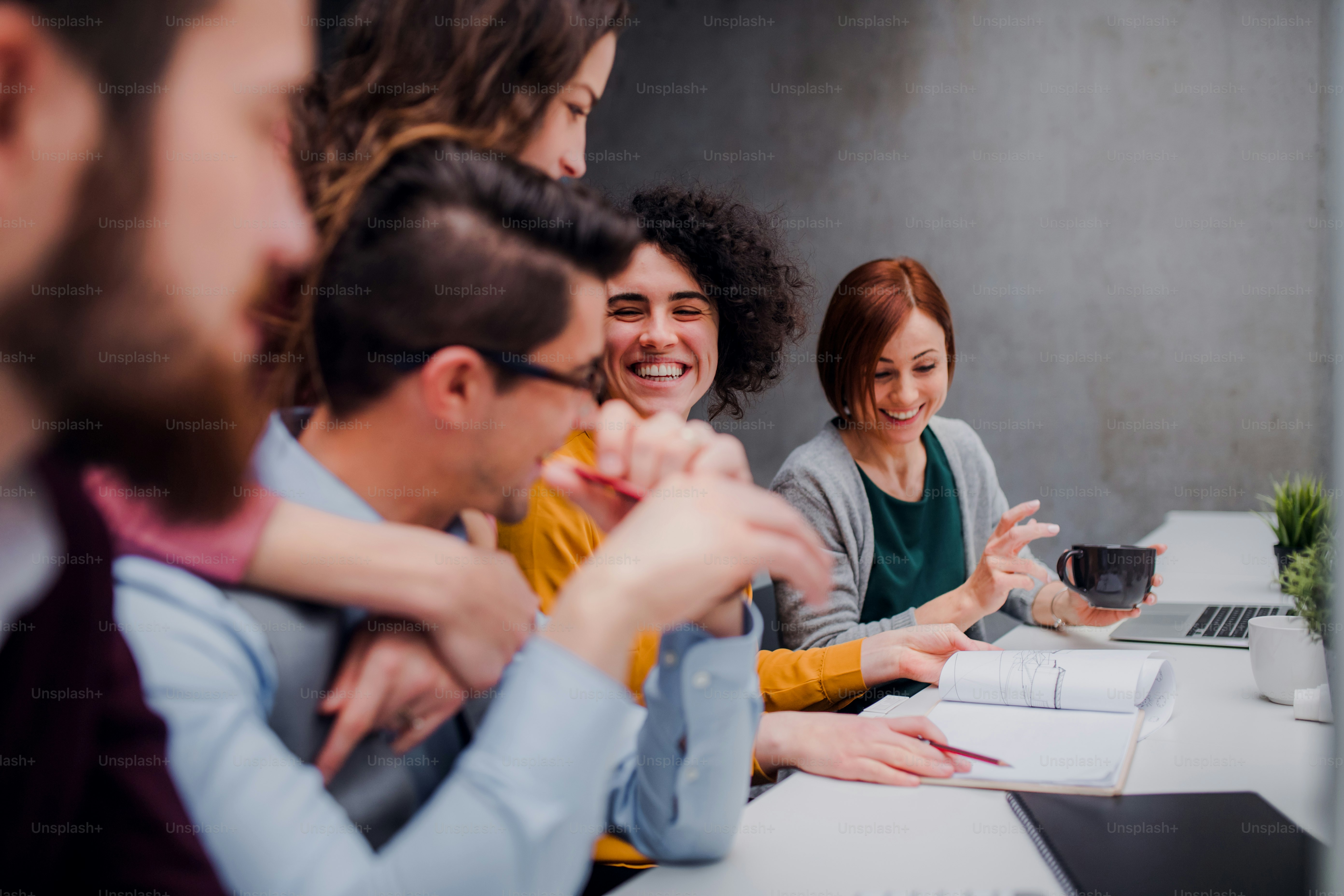 A group of young businesspeople working together in office, talking.