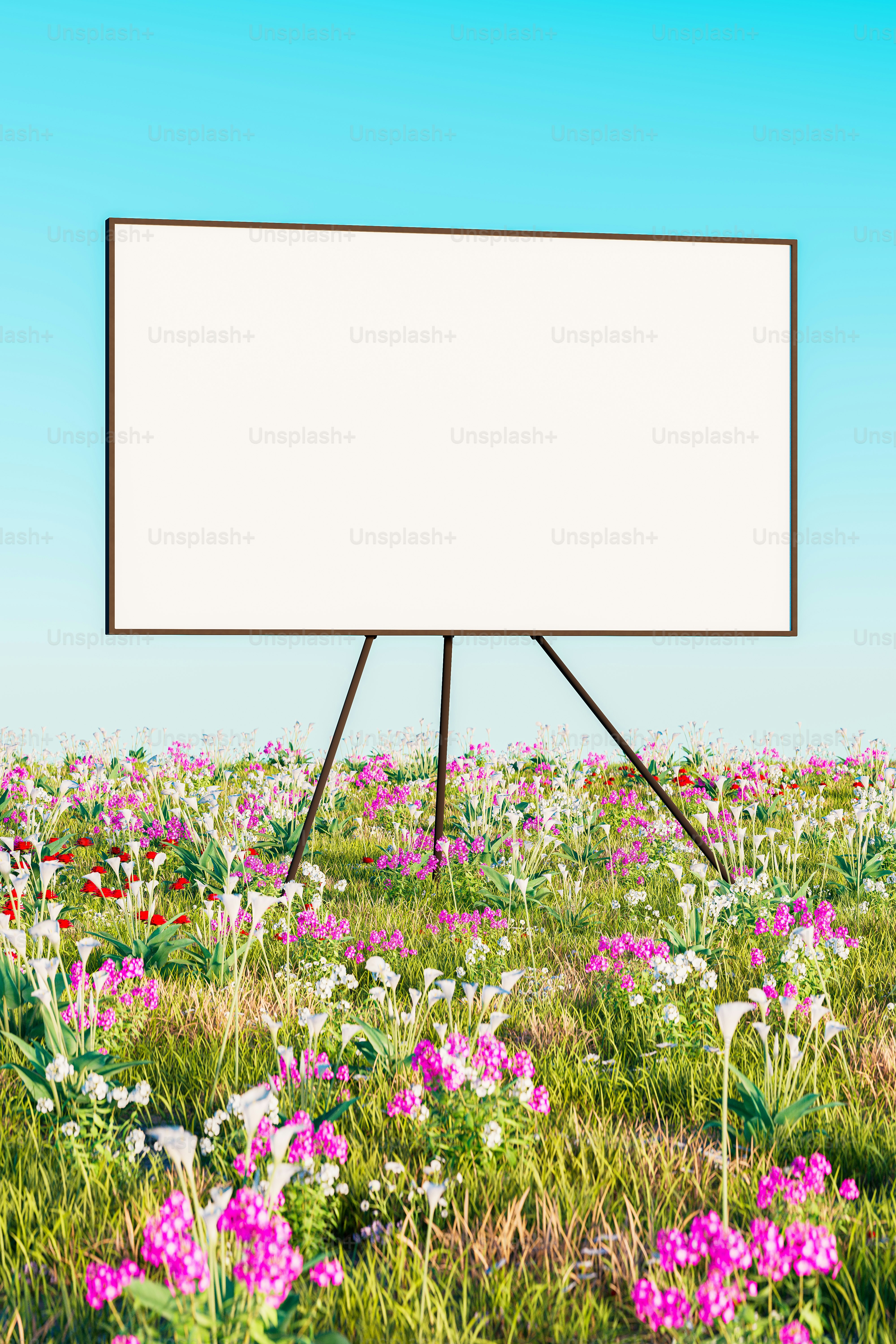 a large white sign in a field of flowers