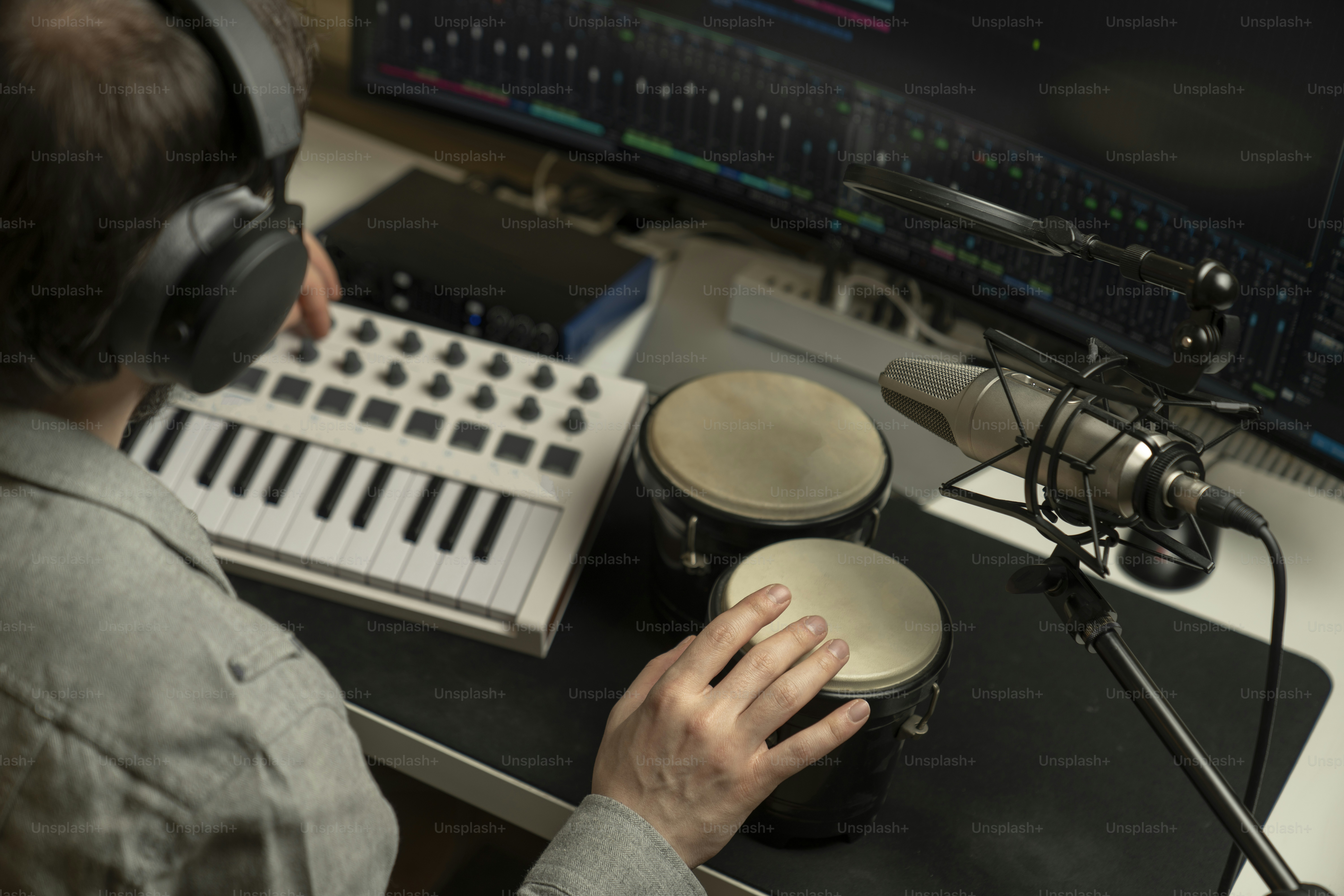 a person sitting at a desk with headphones on