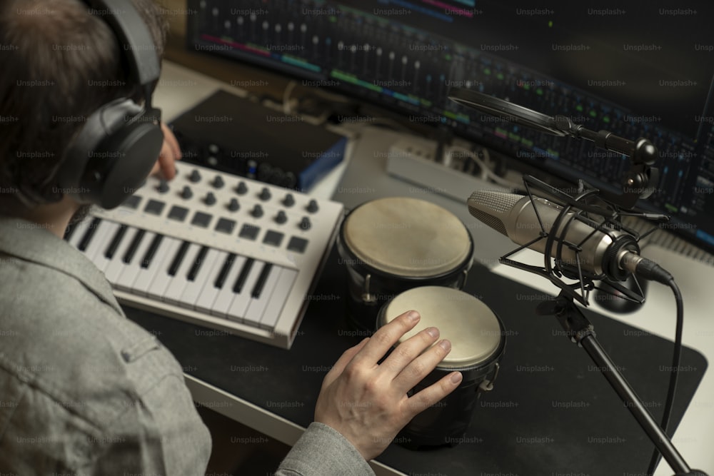 a person sitting at a desk with headphones on