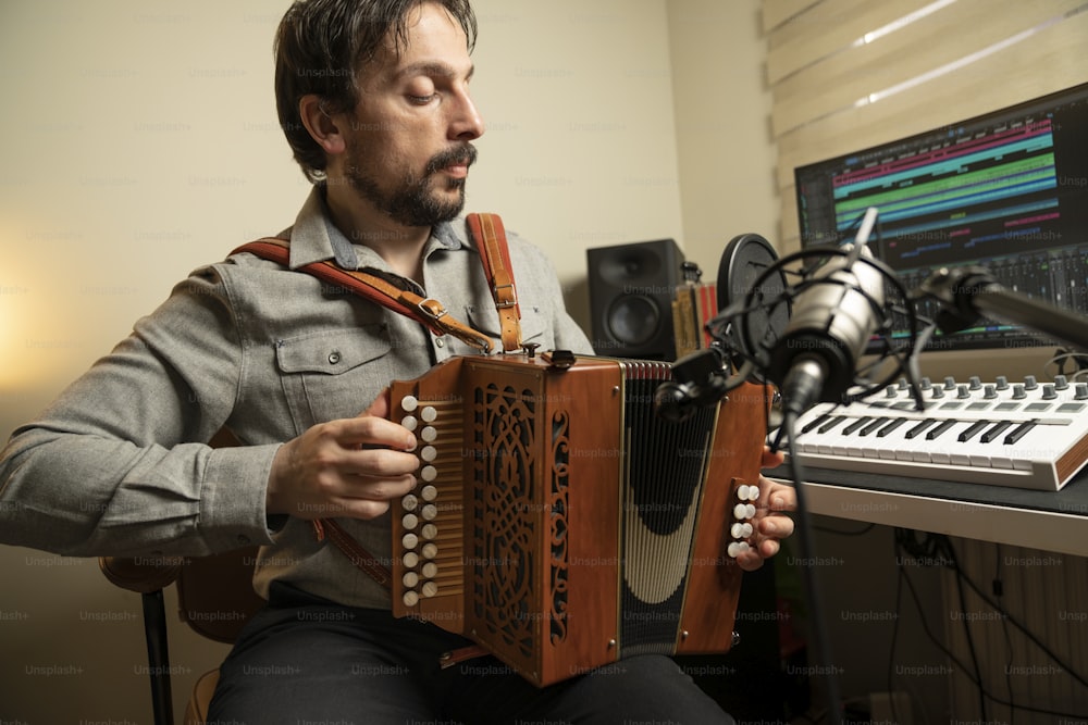 a man playing an accordion in front of a microphone