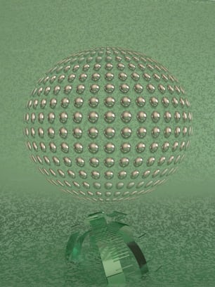 a green glass vase with a ball on top of it