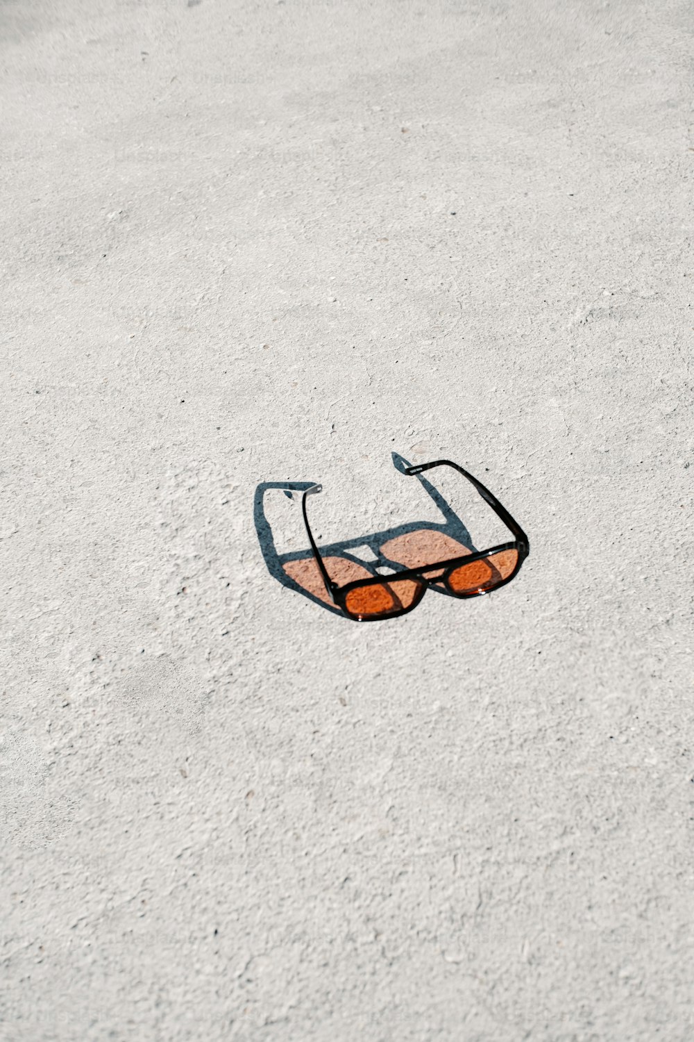 a pair of sunglasses laying on the ground