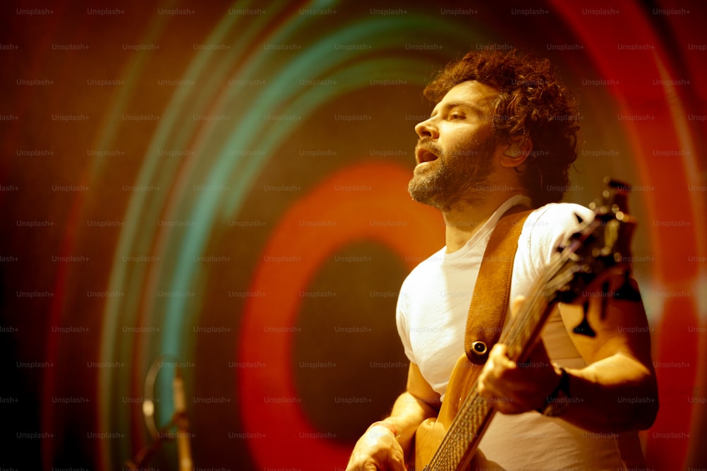 a man playing a guitar on a stage