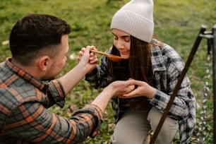 a man feeding a woman a spoon of food