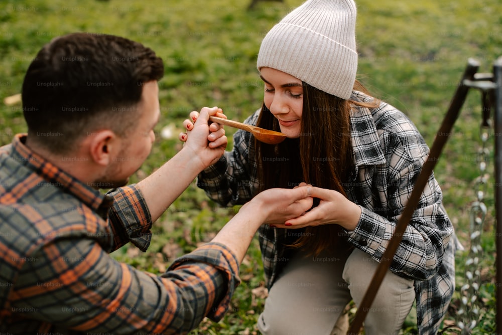 a man feeding a woman a spoon of food