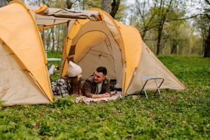 a man and a woman are sitting in a tent