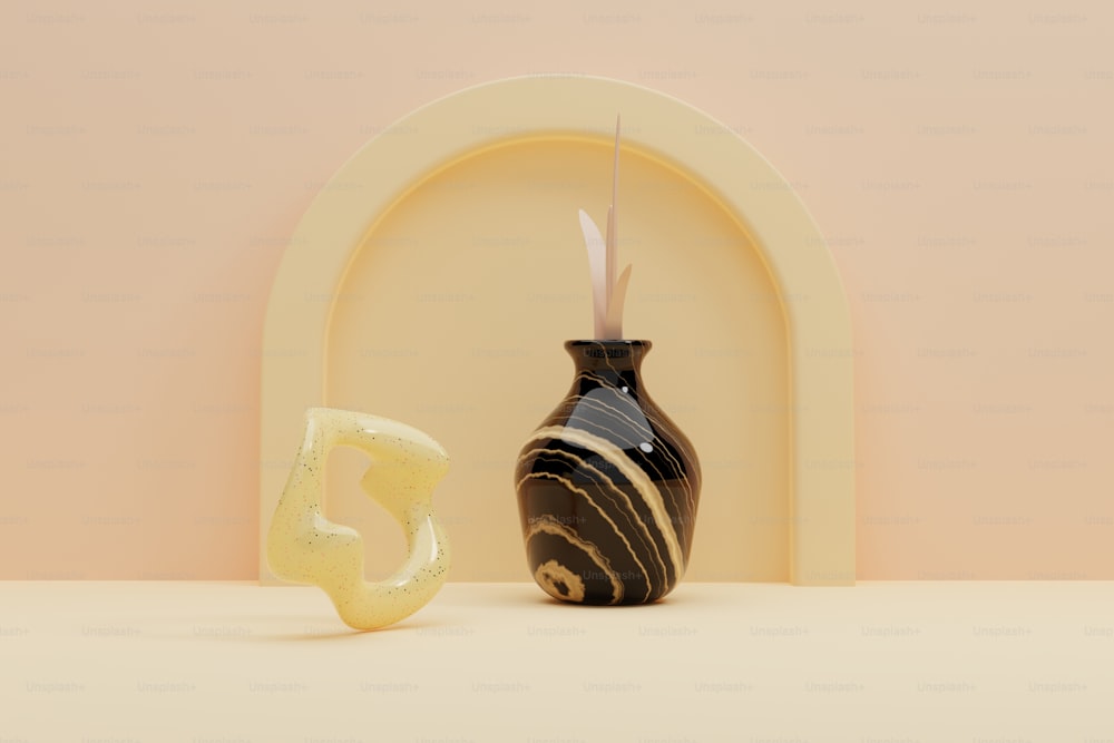 a black and white vase sitting next to a letter e