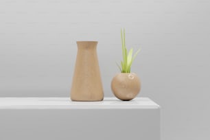 two wooden vases sitting on top of a white table