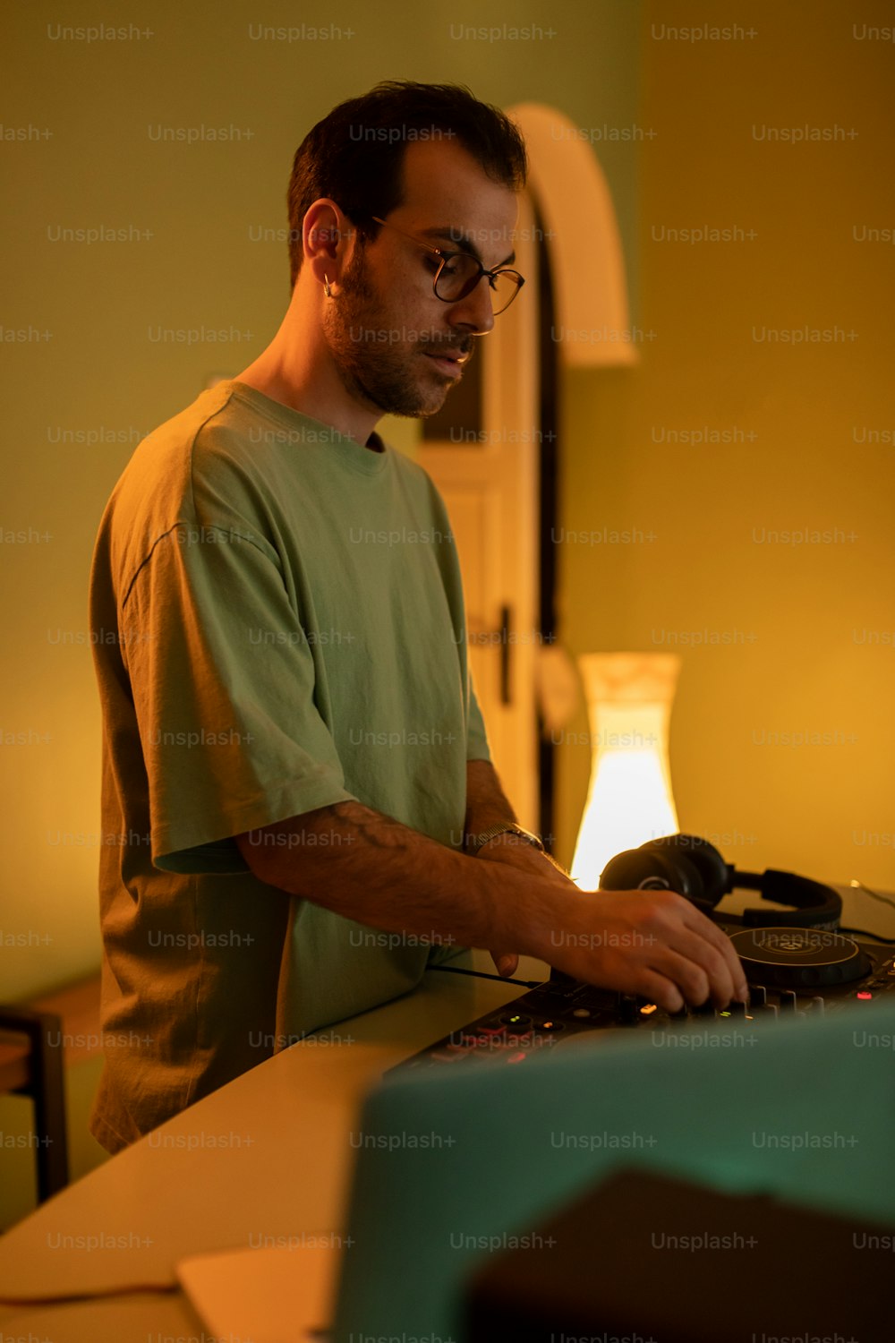 a man in a green shirt is using a laptop