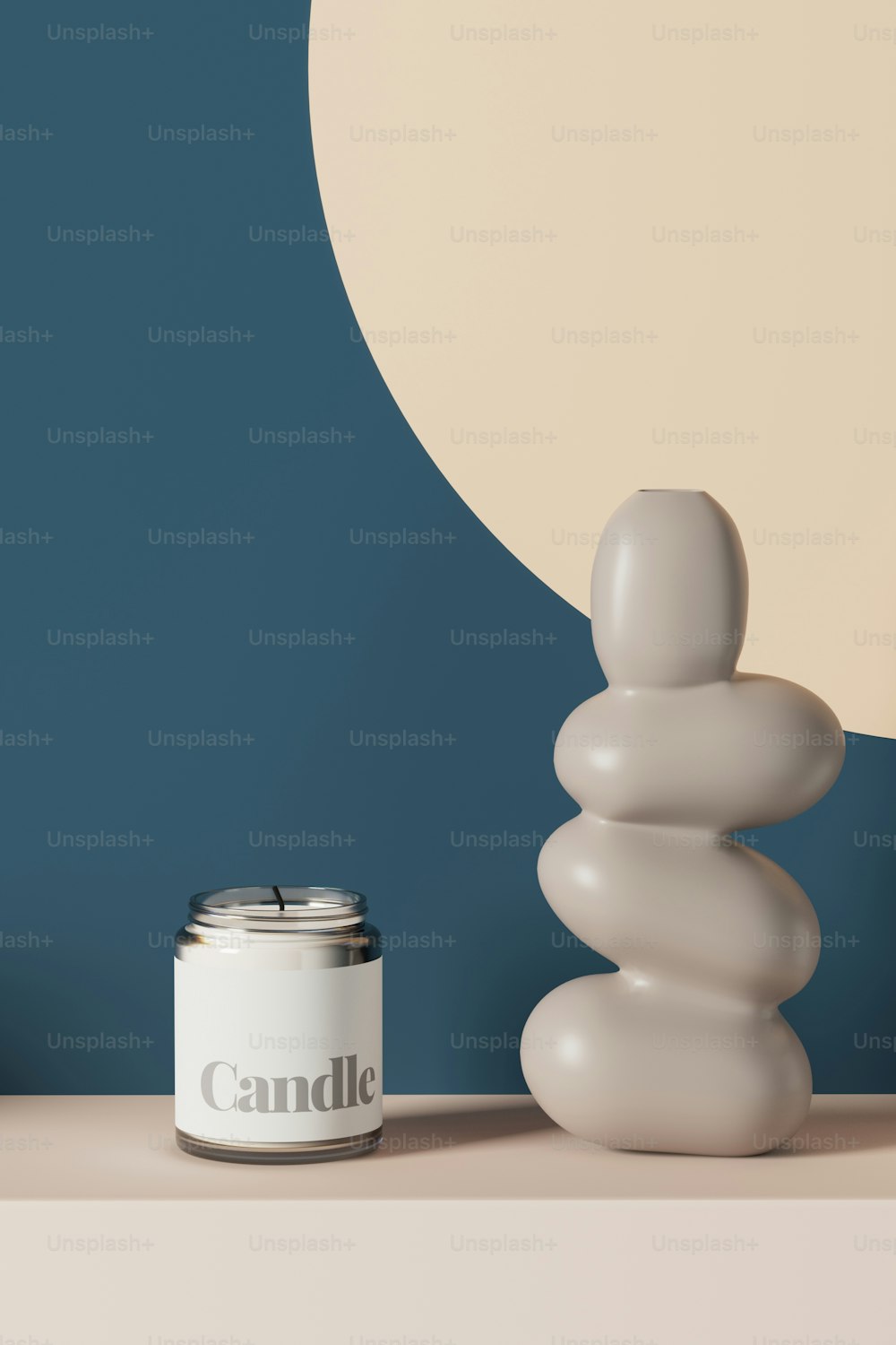 a candle sitting on top of a table next to a stack of rocks