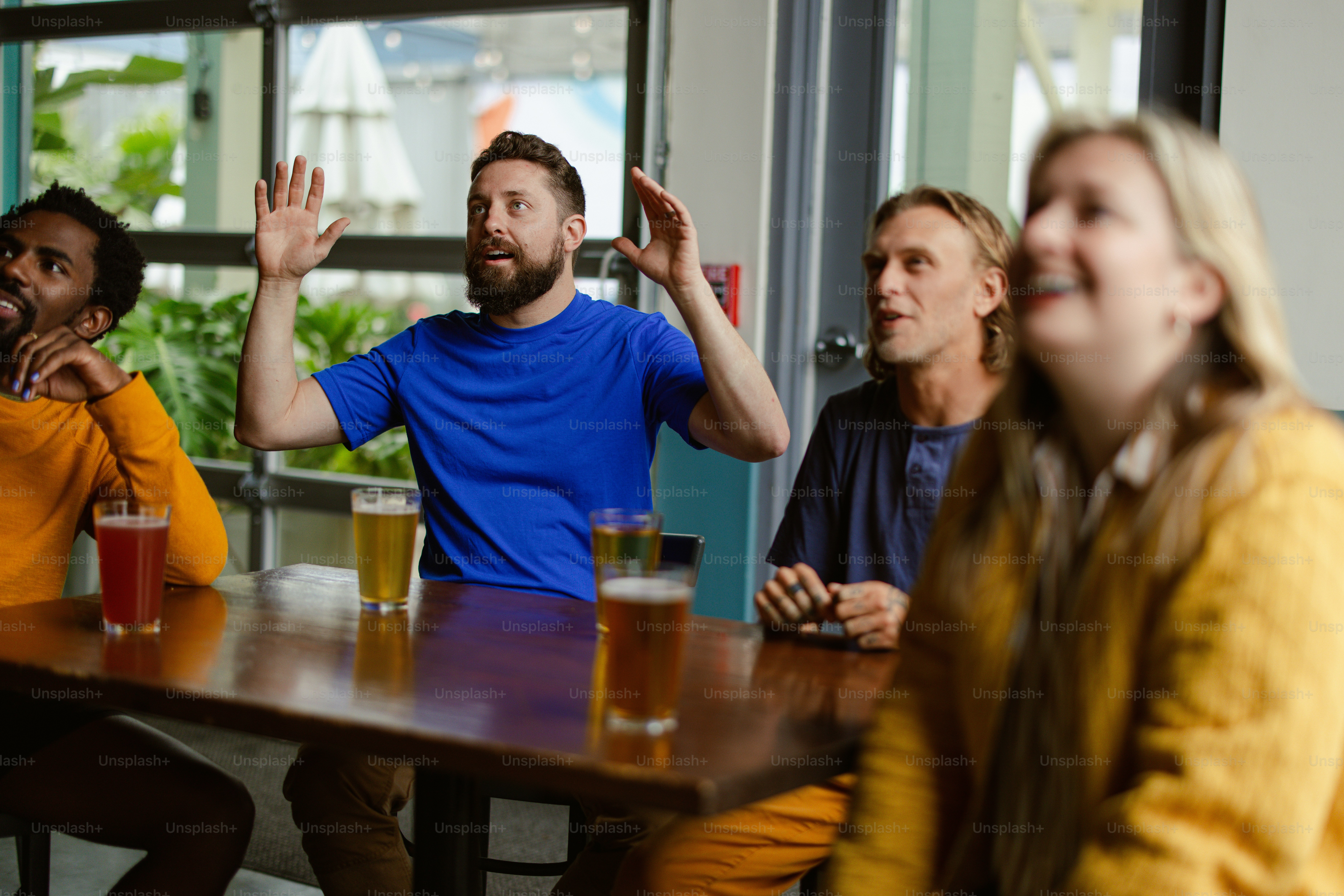 a group of people sitting around a wooden table