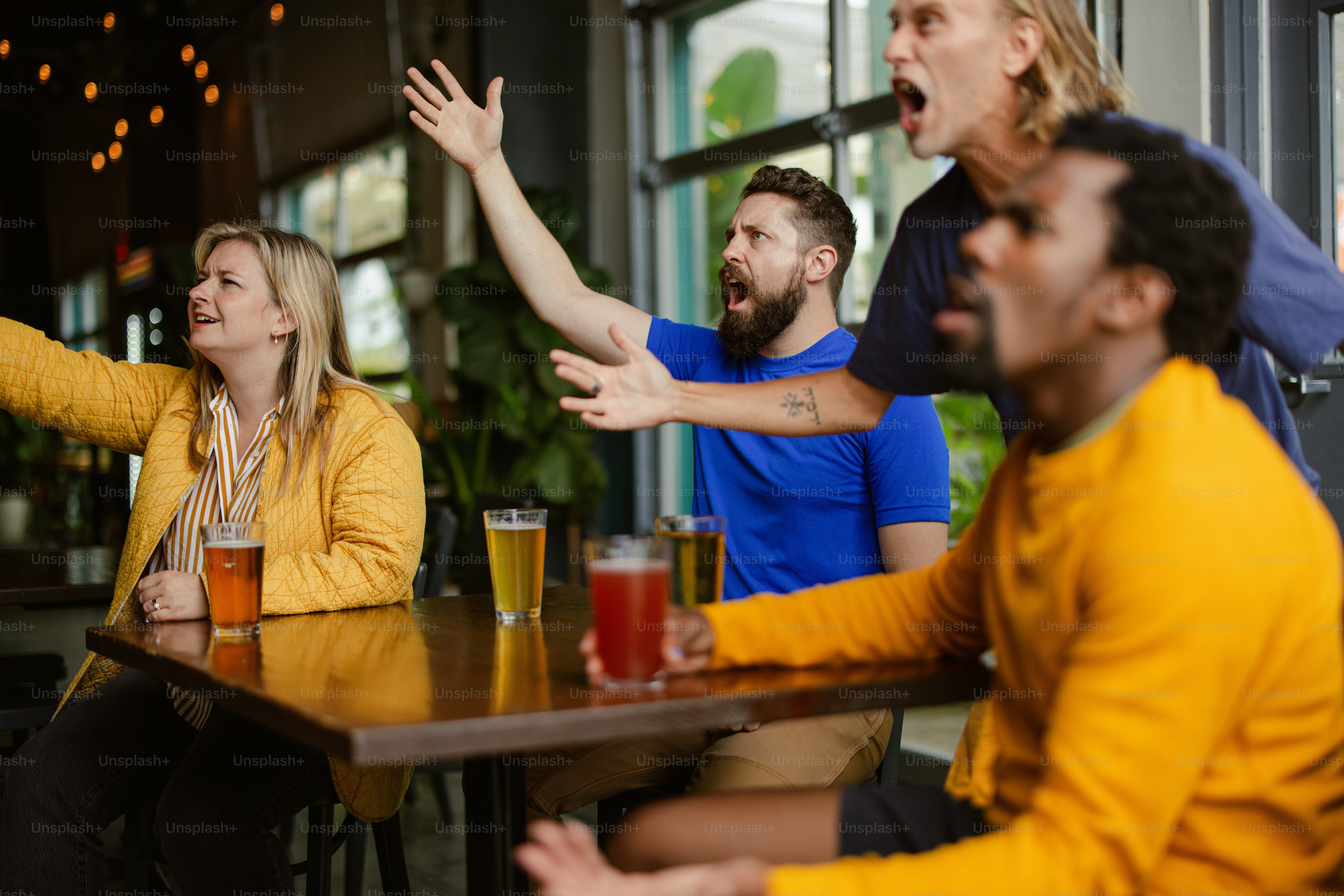 A group of people sitting at a table with drinks photo Crowd Image on
